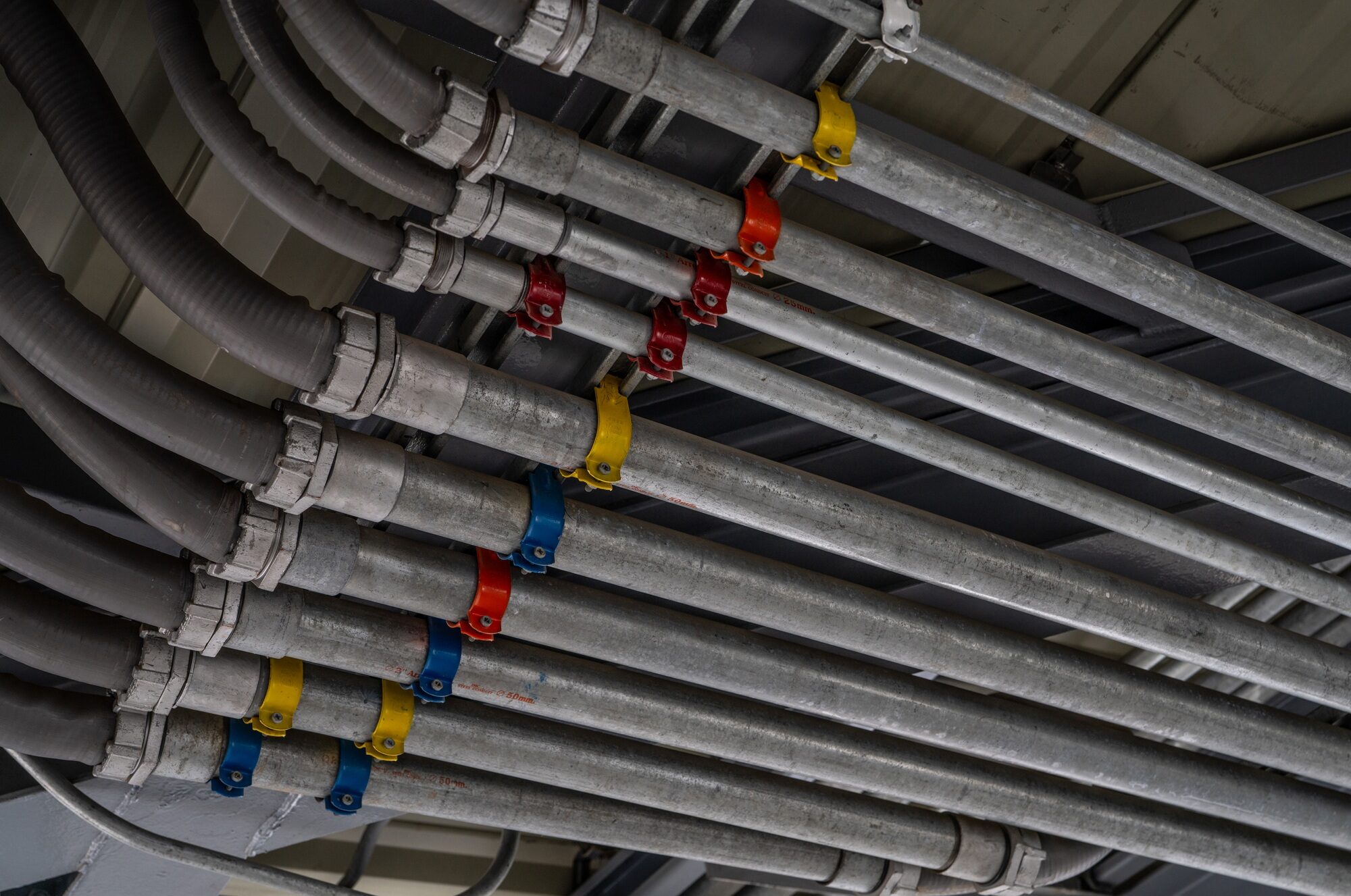 Electrical conduit system and tube of electric cable installed on building ceiling. Industrial